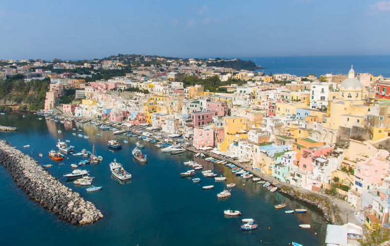 High angle view of townscape by sea against sky in procida island