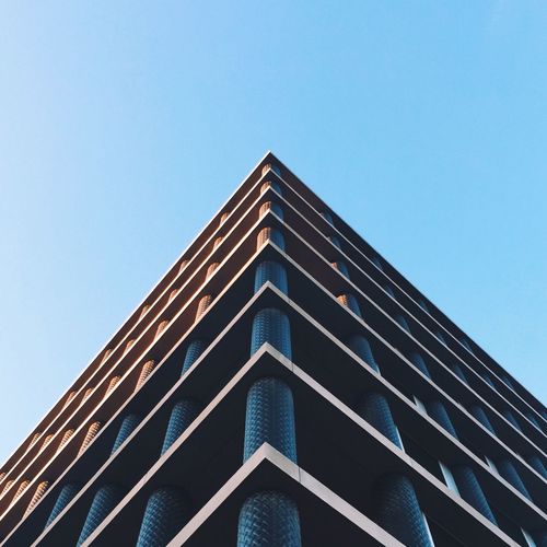 Low angle view of building in city against clear sky