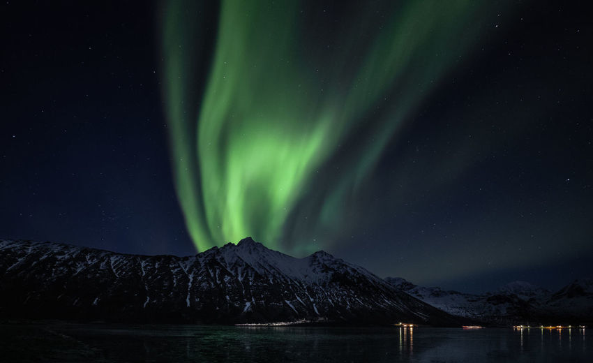 Scenic view of snowcapped mountains against sky at night