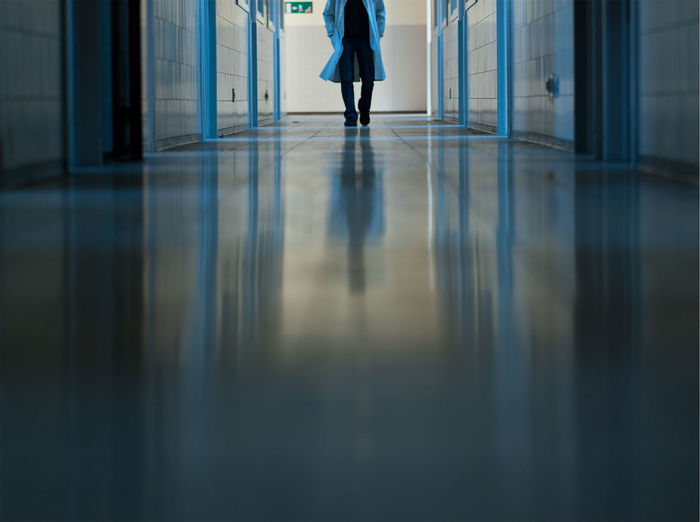 Man doctor walking in hospital corridor