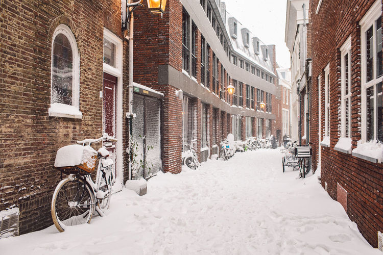 Street amidst buildings in city during winter