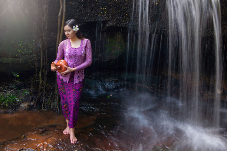 Full length of woman standing in water