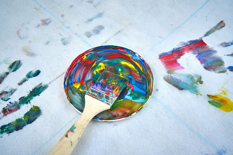 Woman mixes the watercolors brush