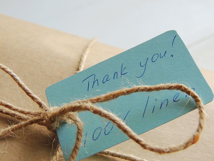 Close-up of gift box with thank you label