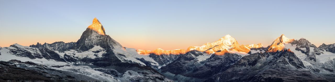 Panoramic view of snowcapped mountains against sky during sunset