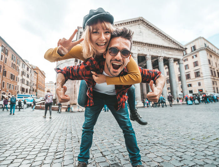 Portrait of happy friends on street in city