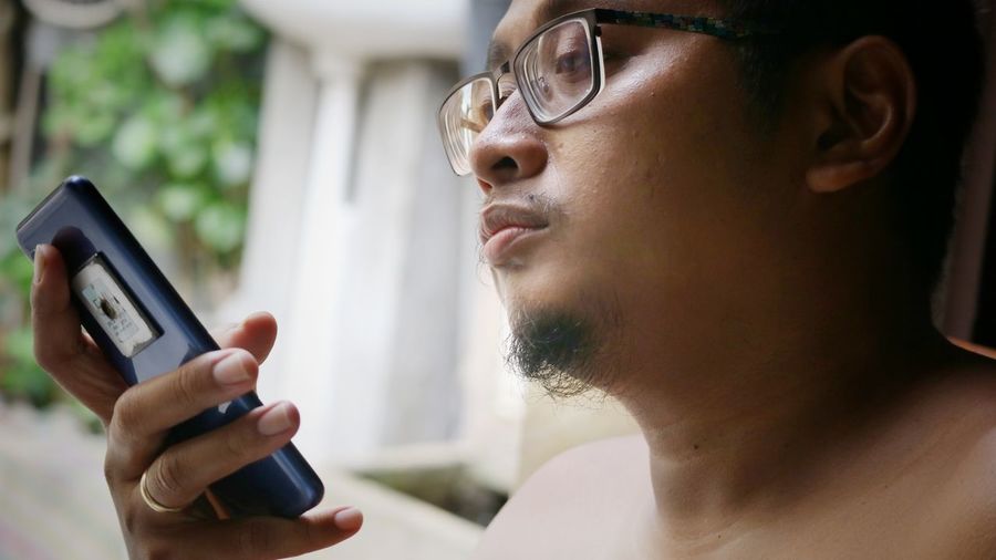 Midsection of man using mobile phone