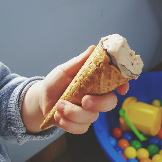 Cropped hand of child holding ice cream