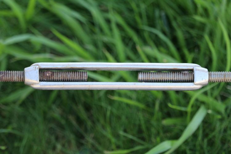 Close-up of metal over grassy field