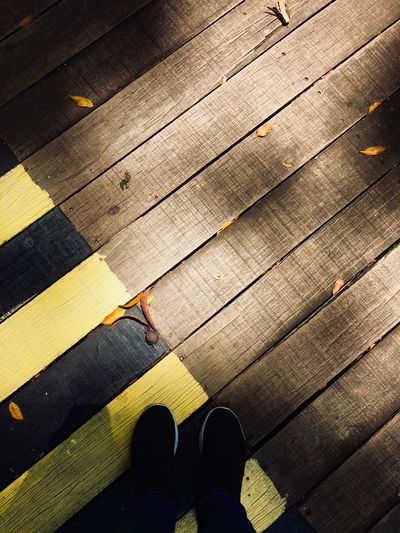 Low section of person standing on tiled floor