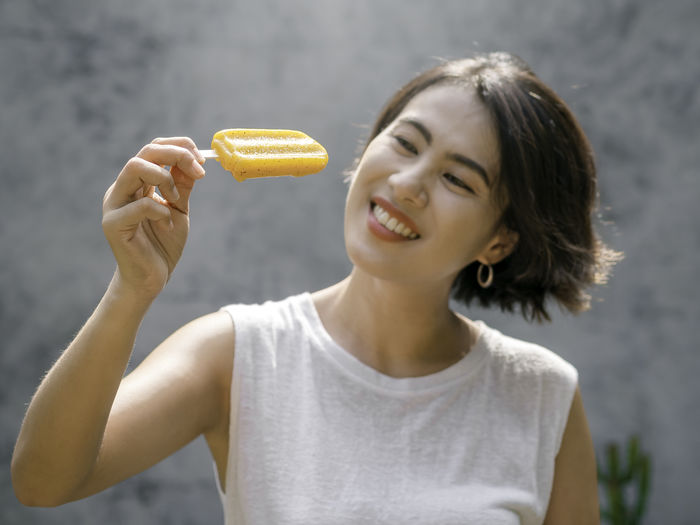 Portrait of smiling woman eating food