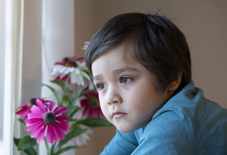 Close-up of boy looking away at home