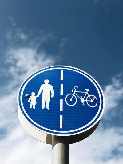 Road sign against blue sky