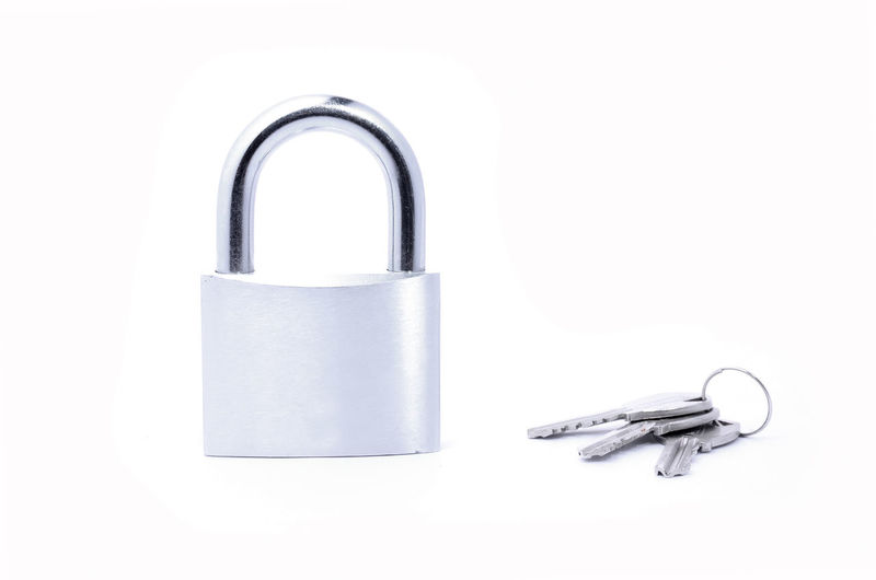 Close-up of padlock against white background