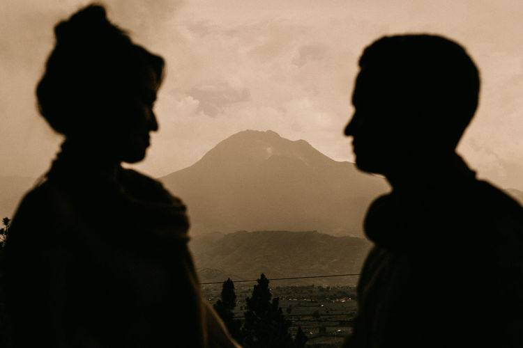 Silhouette couple standing against sky