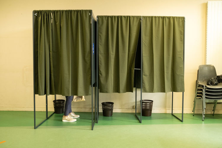 Low section of woman standing in polling place