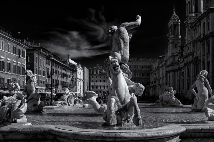 Wide angle image of the fountain of neptune at piazza navona in rome,  black and white photo.