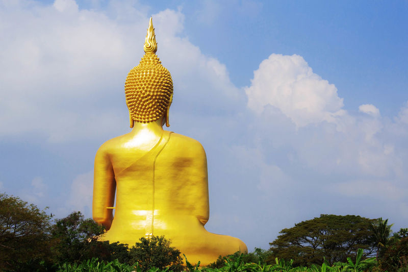 Huge buddha statue against sky