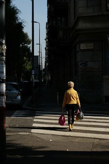 Woman walking on sidewalk