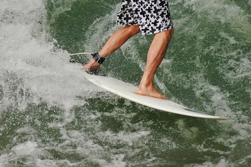 Low section of man surfing
