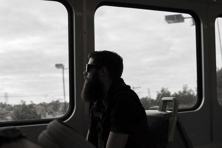 Hipster sitting in train