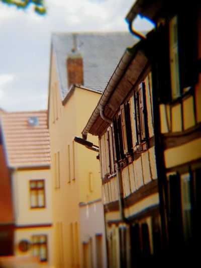 Low angle view of house hanging amidst buildings