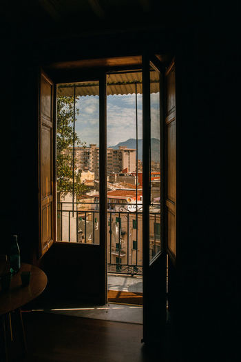 The view on the city with old buildings through the window and balcony, home, tranquil scene. 