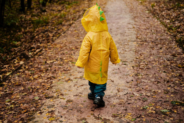 Full length of boy walking in rain
