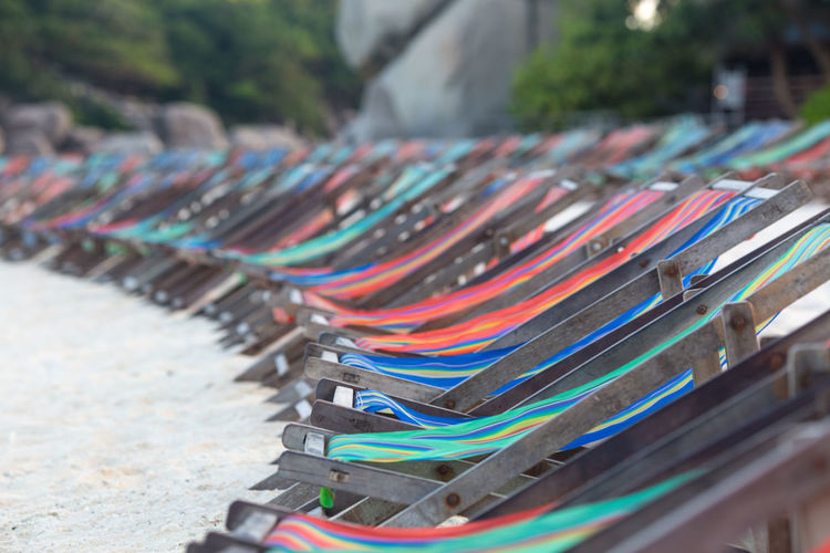 Lounge chairs in row at beach