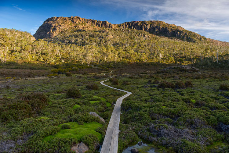 Scenic view of land and mountains against sky