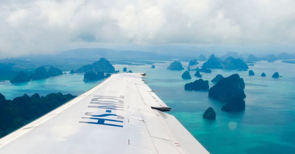 Aircraft wing at andaman islands against cloudy sky