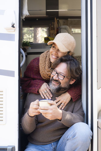 Young woman using phone while sitting in bus