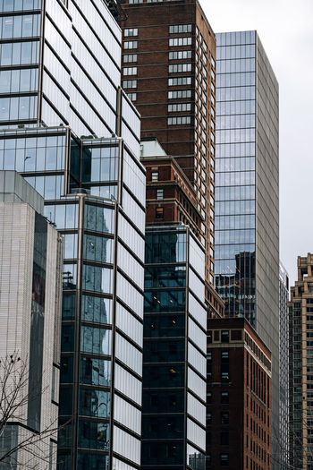 Low angle view of modern buildings in city against sky