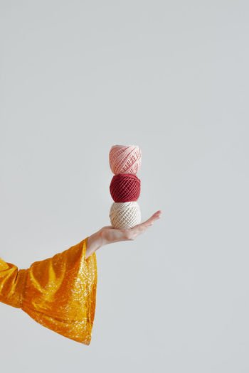 Rolls of cotton ropes in woman hand. knitting, crocheting, handm