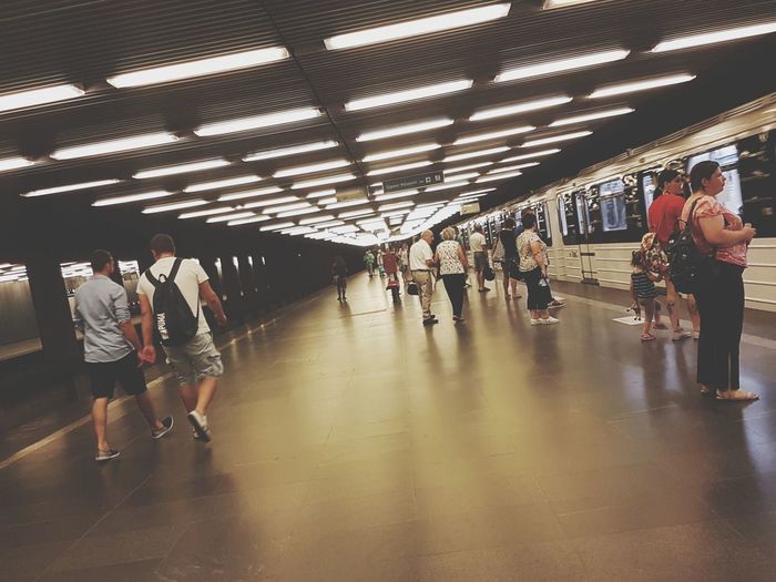 People walking in illuminated underground walkway