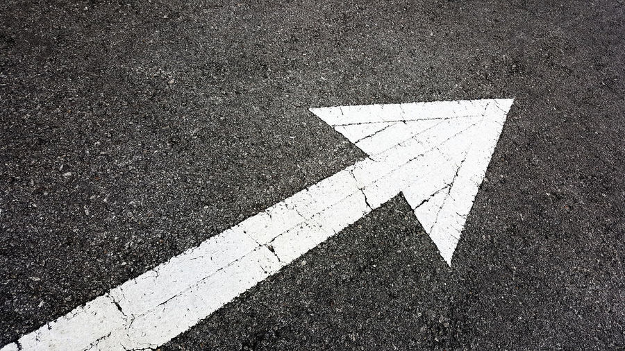 High angle view of arrow symbol on road