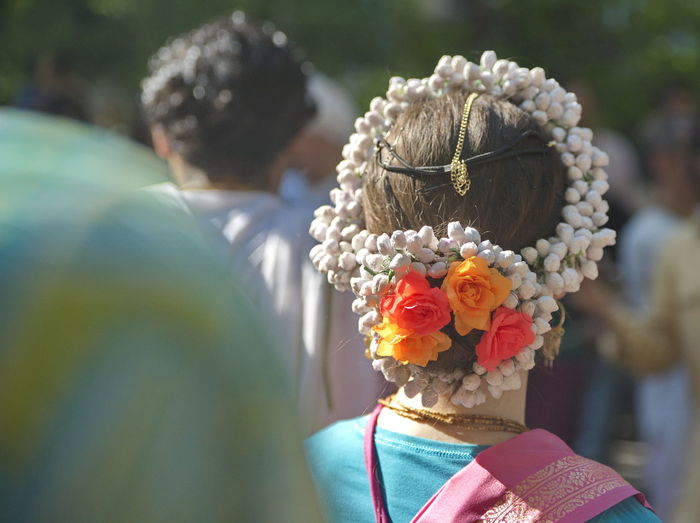 Rear view of woman wearing flowers