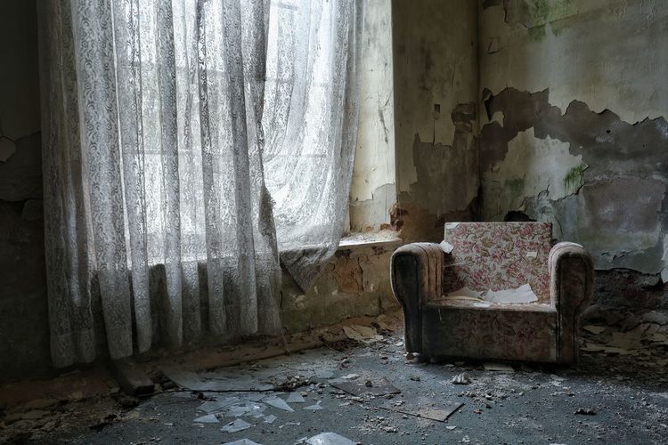 Empty chair in abandoned house