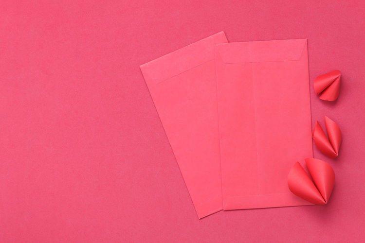 High angle view of envelops on pink background