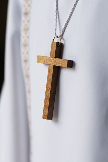 Close-up of cross hanging on wood