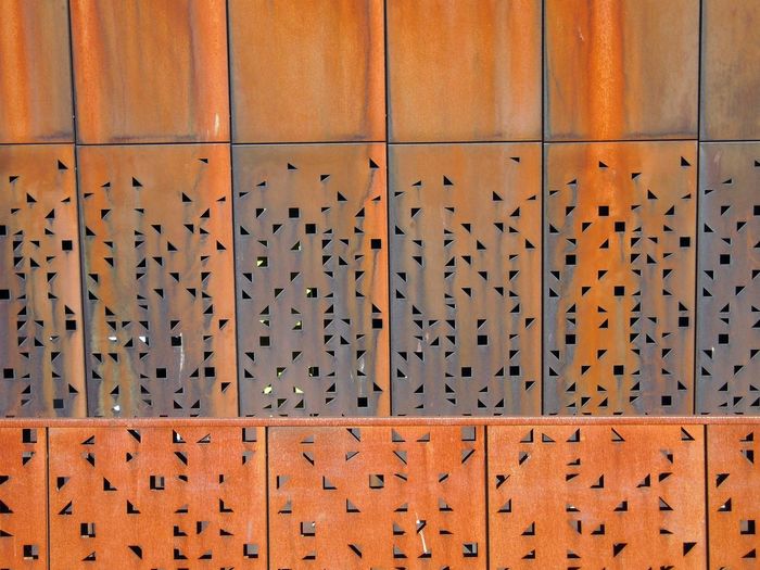 Full frame shot of patterned orange metallic wall