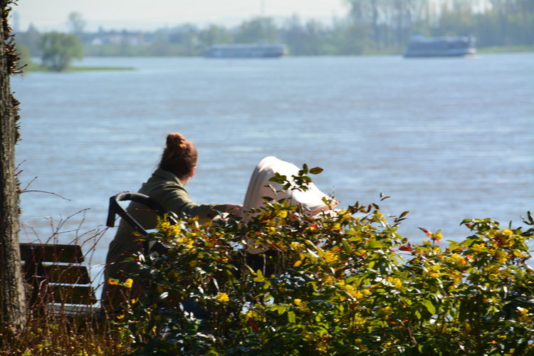 Side view of a woman overlooking calm lake