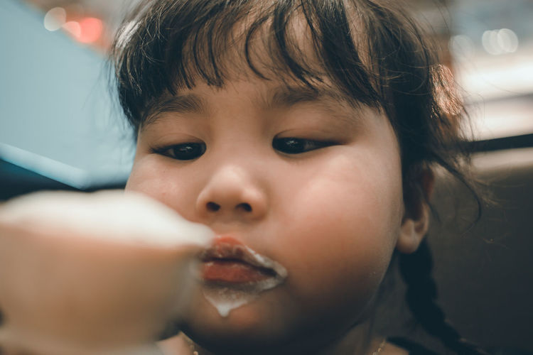 Close-up of cute girl eating ice cream