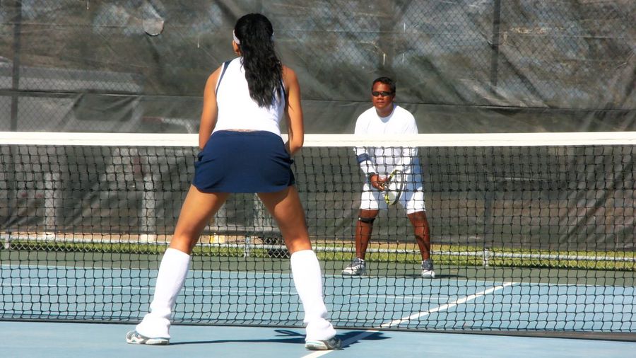 Players playing tennis in court