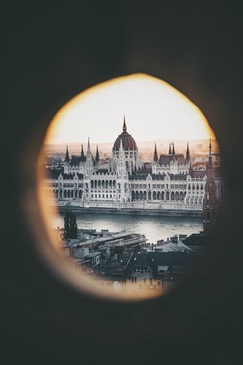 Hungarian parliament building and danube river in city seen through window