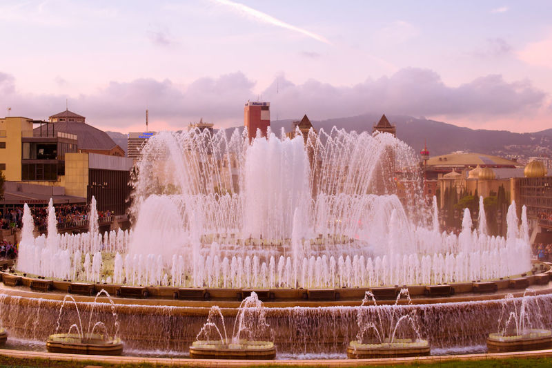 Panoramic view of fountain in city against sky