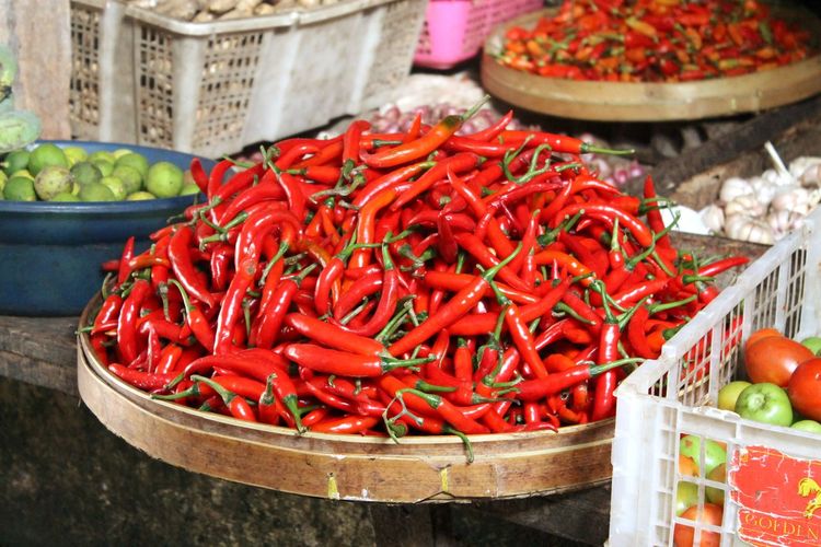 Red chili peppers in basket for sale at market stall