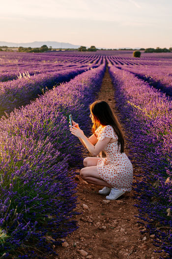 Shadow of woman on purple flowering field