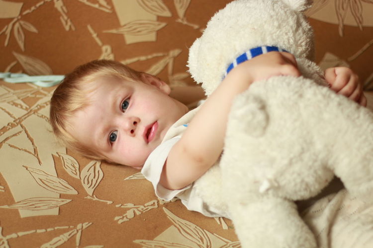 Portrait of cute baby girl with teddy bear