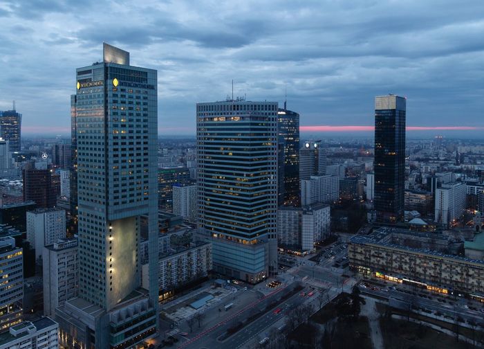 Cityscape against cloudy sky at dusk